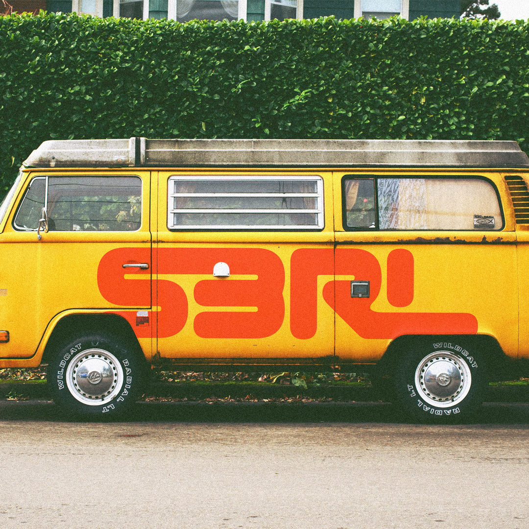 S3RL logotype in red, painted on a yellow van.
