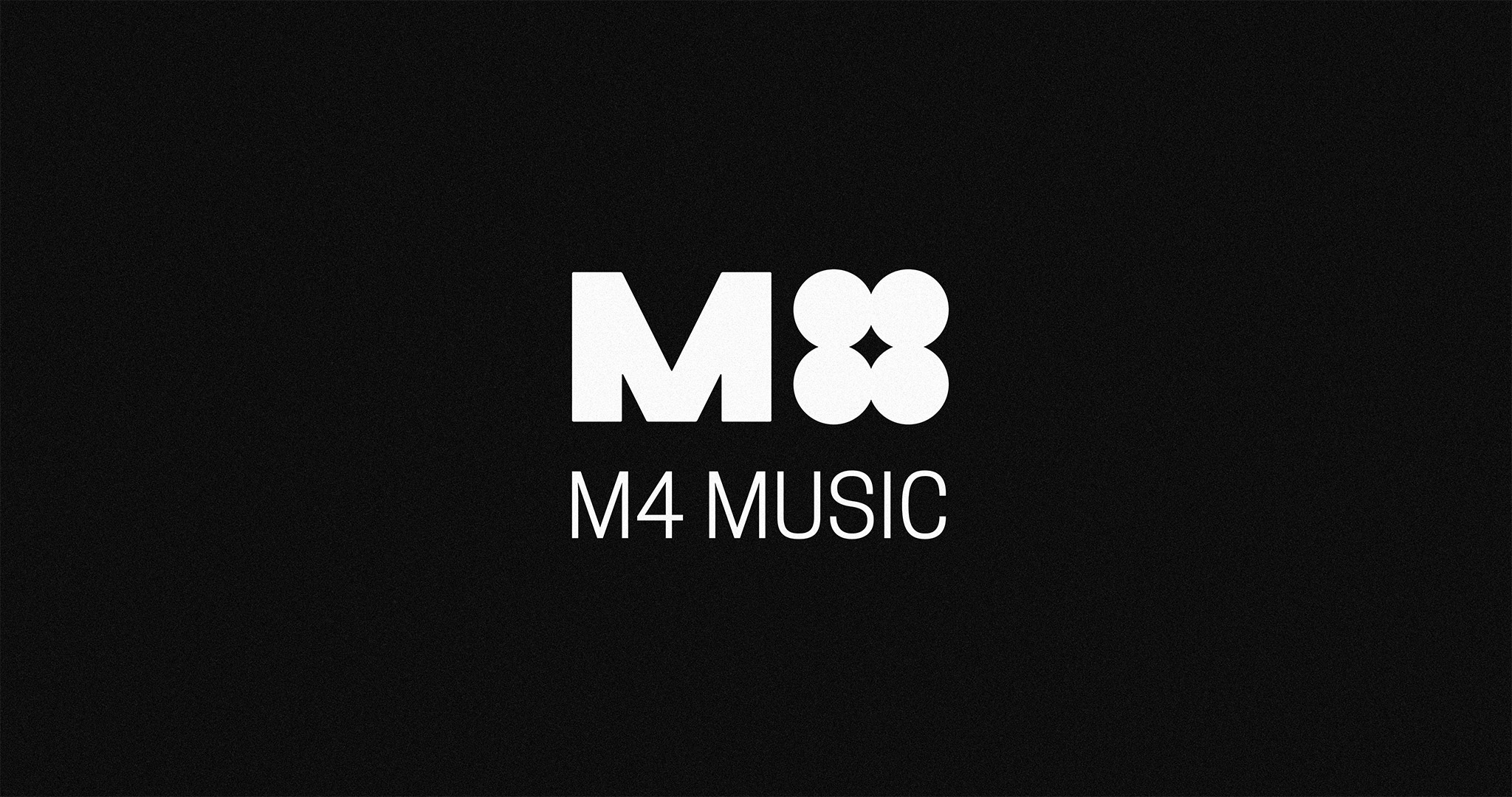 The M4 Music logotype. It features a bold, industrial, uppercase ‘M’, and 4 circles grouped together to represent the number ‘four’; accompanied by text reading ‘M4 MUSIC’ underneath in all-caps. White logotype over black background.