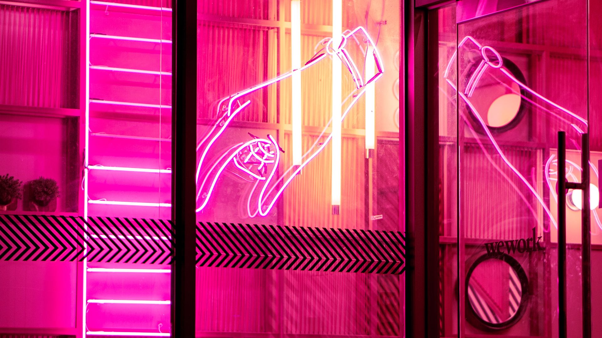 Interior completely lit by illustrative, pink or magenta neon signs.