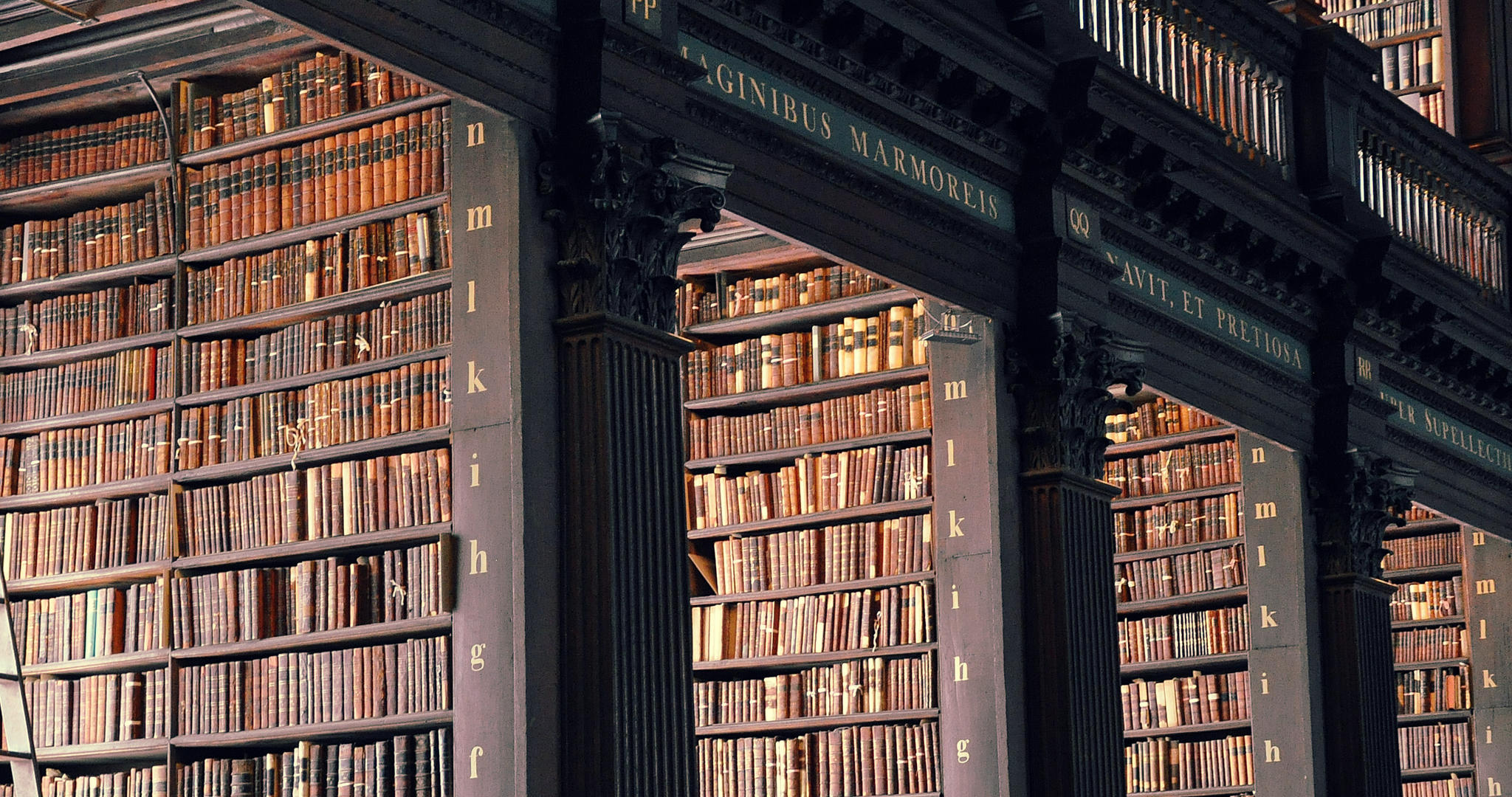 View of massive, book-filled shelves within a library.